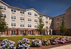 Rahway apartment for rent - an apartment building with flowers in front of it