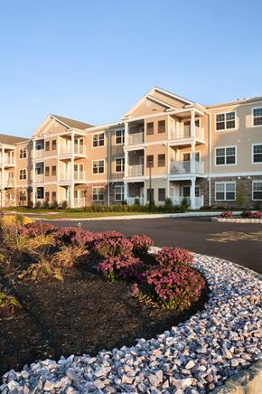 Forked River apartment for rent - an exterior view of an apartment building with flowers in front of it