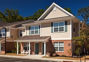 Toms River apartment for rent - a white house with a porch and a chair in front of it