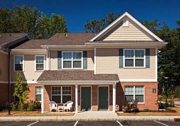 Jackson townhouse for rent - A two-story house with a red brick base and a beige upper section.