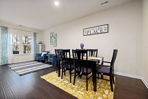 Cary house for rent - A dining room with a table set for four.