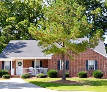 Clayton apartment for rent - A house with a tree in front of it.
