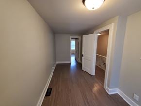Lima apartment for rent - A hallway with a light on the ceiling and a door on the right.