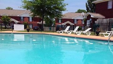 Tupelo apartment for rent - A pool with a sign in front of a house.
