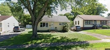 Elizabethtown house for rent - A tree in front of a yellow house.