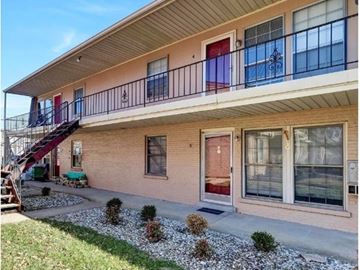 Louisville apartment for rent - A house with a red door and a balcony.