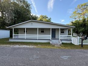 St. Augustine house for rent - A small house with a porch and a white picket fence.