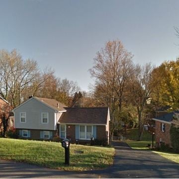 Louisville house for rent - A residential street with two houses and a mailbox.