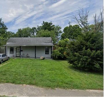 Louisville house for rent - A small house with a gray roof and a car parked in front.