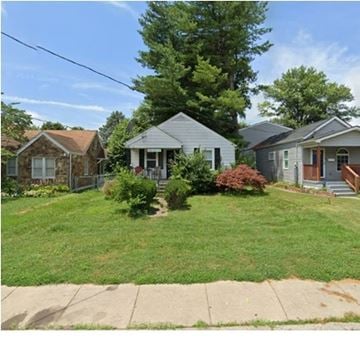 Louisville house for rent - A house with a grey roof and a green lawn in front.