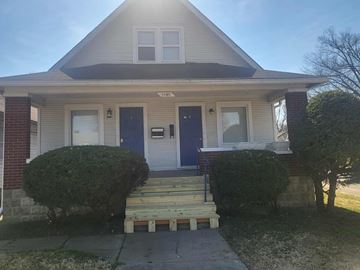 Louisville apartment for rent - A house with a blue door and windows is shown.