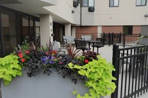 Minneapolis apartment for rent - A black metal fence is in front of a building.