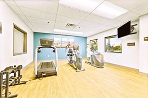 Minneapolis apartment for rent - A gym room with a treadmill, weights and exercise bike.