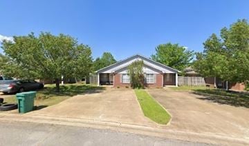 Tupelo apartment for rent - A house with a green lawn in front.