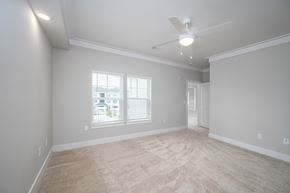 Fortson apartment for rent - A spacious room with a ceiling fan and a window with blinds.