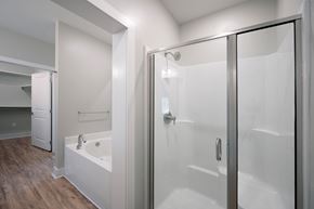 Fortson apartment for rent - A white bathroom with a walk in shower and a bathtub.