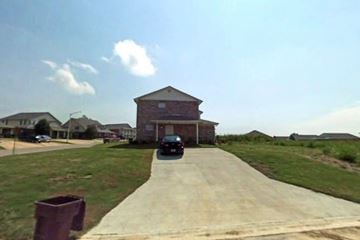 Tupelo apartment for rent - A car is parked on a driveway in front of a house.