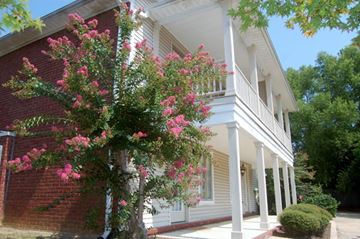 Tupelo apartment for rent - A white house with a tree in front of it.