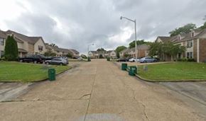 Tupelo apartment for rent - A street view of a residential area with houses on both sides.