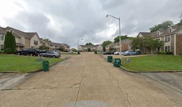 Tupelo apartment for rent - A street view of a residential area with houses on both sides.