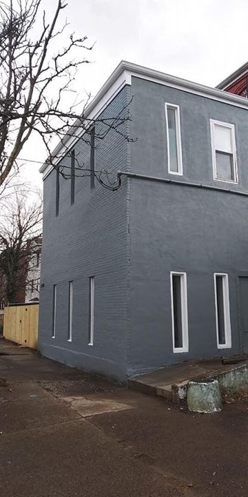 Louisville apartment for rent - A grey building with a tree in front of it.