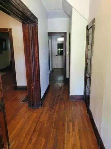 Louisville apartment for rent - A hallway with a wooden floor and white walls.