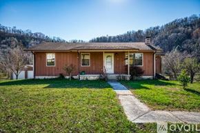 La Follette house for rent - A house with a brown roof and white trim is for sale.
