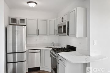 Chicago apartment for rent - A kitchen with white cabinets and appliances.