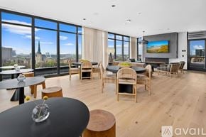 Chicago house for rent - A modern living room with a view of the city skyline.