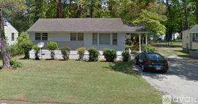 Kinston house for rent - A house with a car parked in front.