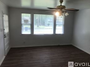 Kinston house for rent - A room with a ceiling fan and two windows.