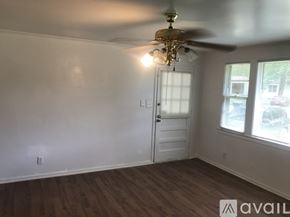 Kinston house for rent - A room with a ceiling fan and a door.