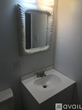 Kinston house for rent - A bathroom with a white sink and mirror.