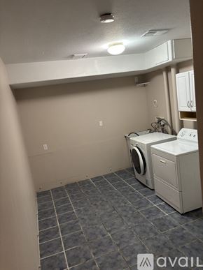 Aurora townhouse for rent - A house with a grey and blue exterior is available for rent.
