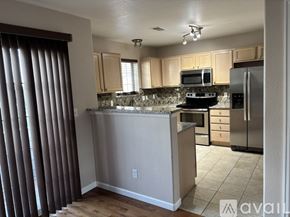 Aurora townhouse for rent - A living room with a wooden floor and a television.