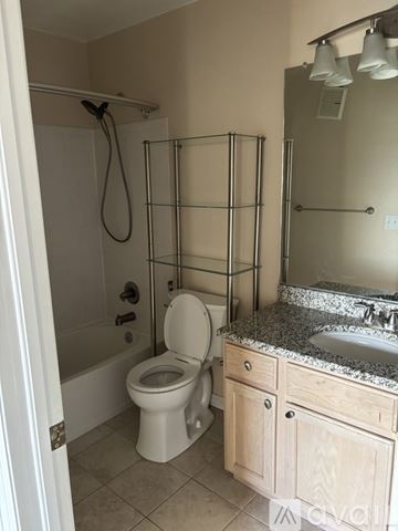 Aurora townhouse for rent - A kitchen with wooden cabinets and granite countertops is available for rent.
