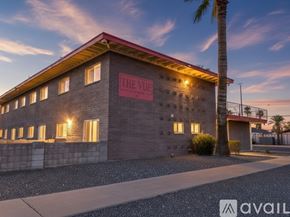 Phoenix apartment for rent - A living room with a grey couch, a television, a coffee table, and a ceiling fan.
