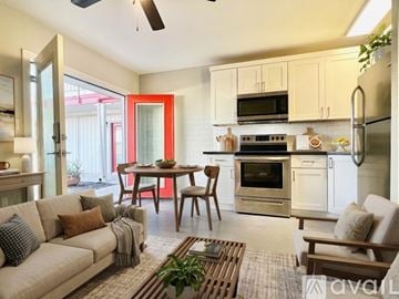 Phoenix apartment for rent - A kitchen with a refrigerator, microwave, and oven is visible through a doorway.