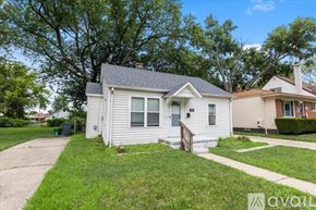 Hazel Park house for rent - A house with a front yard and a driveway.