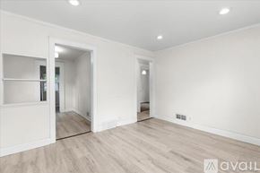 Hazel Park house for rent - A spacious room with wooden flooring and white walls.