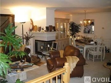 Gaithersburg house for rent - A living room with a brown leather chair and a white couch.