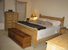 Gaithersburg house for rent - A bedroom with a bed, nightstand, and a wooden chest.