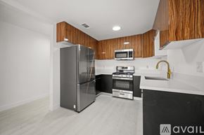 Los Angeles apartment for rent - A kitchen with a refrigerator, microwave, oven, and sink.