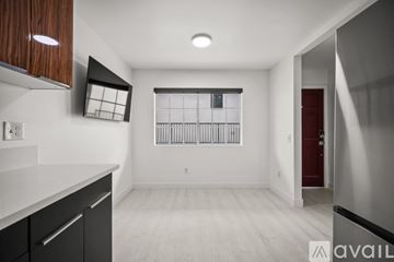 Los Angeles apartment for rent - A modern kitchen with dark wood cabinets and a red door.