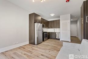 Chicago apartment for rent - A modern kitchen with wooden floors and stainless steel appliances.
