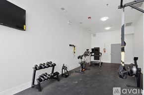 Chicago apartment for rent - A gym with a variety of equipment including a rowing machine, a stationary bike, and a bench press.