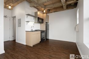 Chicago apartment for rent - A kitchen area with wooden floors and white walls.