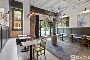 Chicago apartment for rent - A modern dining area with wooden chairs and tables.