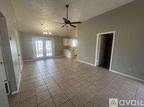 Axtell house for rent - A spacious room with tile flooring and a ceiling fan.