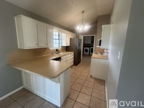 Axtell house for rent - A kitchen with white cabinets and a countertop.